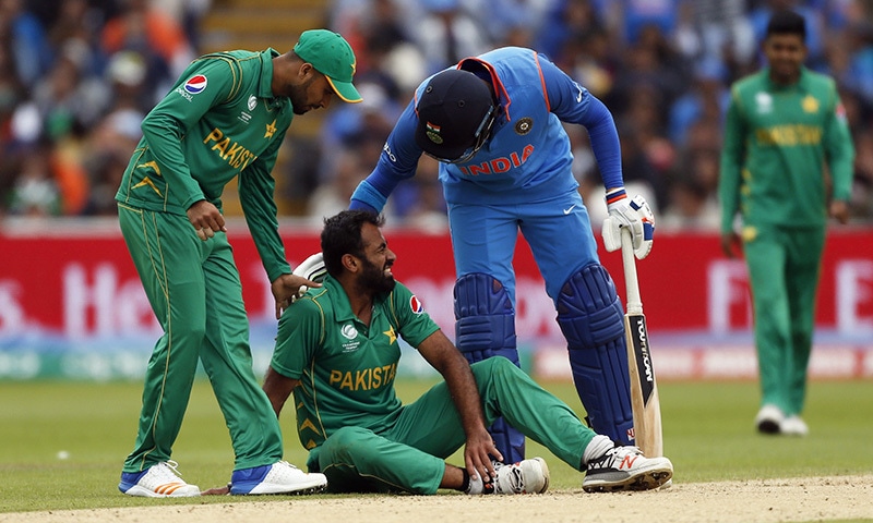 India's Yuvraj Singh goes to Wahab Riaz who is injured during Pakistan's opening Champions Trophy clash.— Reuters