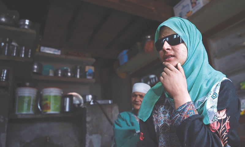 Kashmiri student Inshah Mushtaq, who was blinded in both eyes after being hit by shotgun pellets fired by Indian forces, sits at her home in the village of Sedav last month.—AFP