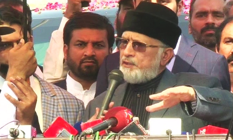 PAT chief Tahirul Qadri speaks to reporters at Lahore airport upon his return from Canada.