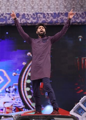 Fahad Mustafa awards a car and then puts it at risk of dents by climbing on to its roof