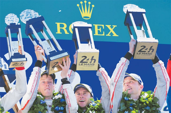 LE MANS (France): (LtoR) New Zealand’s drivers Brendon Hartley, Earl Bamber and Germany’s driver Timo Bernhard celebrate with their trophies on the podium after winning the 85th Le Mans 24-hour endurance race on Sunday.—AFP