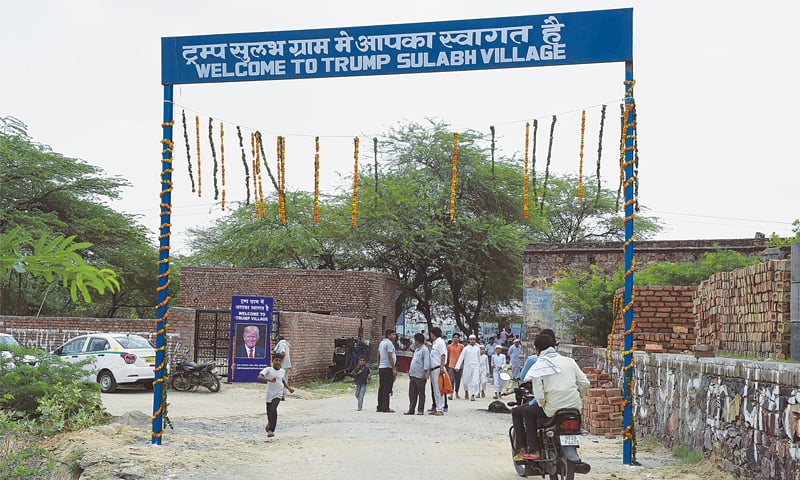 New Delhi: Residents pass through the entrance to Marora village, which has been unofficially renamed ‘Trump Village’.—AFP