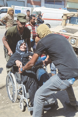 Mosul: People fleeing the old area of this city arrive in the industrial district on Friday.&mdash;AFP