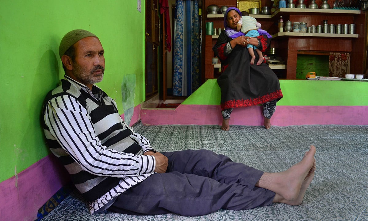 Parents of slain Arif Ahmed Shah, Mohammad Amin Shah and Firdousa, with their granddaughter at their home in Sangam village