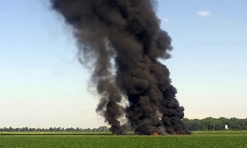 In this photo provided by Jimmy Taylor, smoke and flames rise into the air after a military transport airplane crashed in a field near Itta Bena, Miss., on the western edge of Leflore County, Monday, July 10.— AP In this photo provided by Jimmy Taylor, smoke and flames rise into the air after a military transport airplane crashed in a field near Itta Bena, Miss., on the western edge of Leflore County, Monday, July 10.— AP