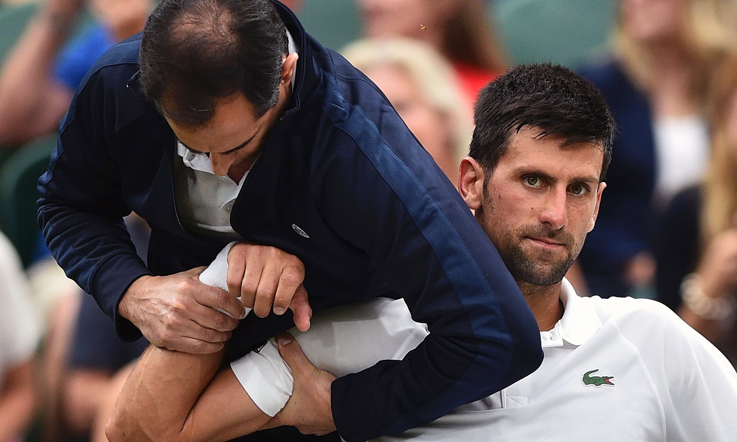 Novak Djokovic receiving medical attention during a break between games against France's Adrian Mannarino. &mdash;AFP
