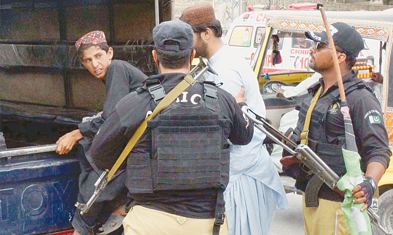 QUETTA: Policemen arrest PPP workers during a protest in front of the election commission office on Sunday.&mdash;INP