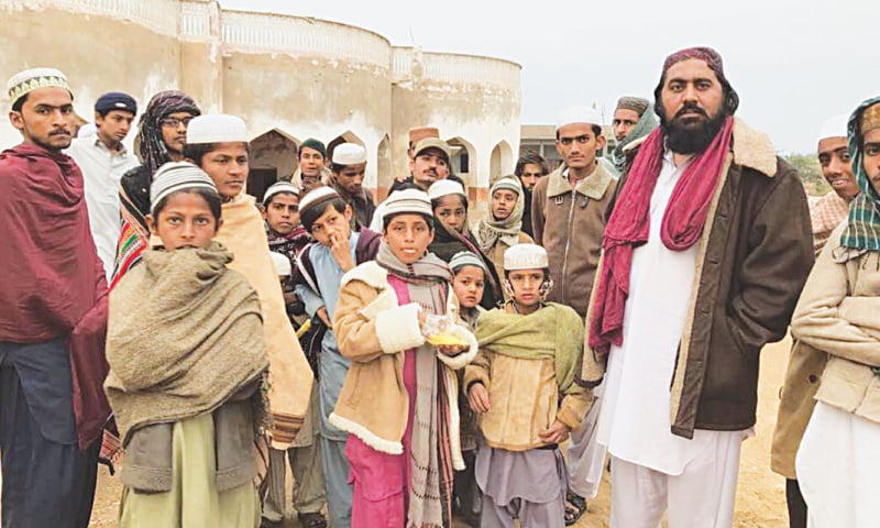 Students at Pir Ayub Jan Sarhandi’s madressah in Samaro with the seminary’s caretaker.—White Star