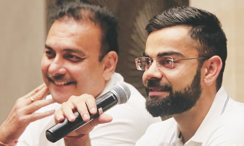 MUMBAI: Indian captain Virat Kohli and head coach Ravi Shastri smile during a news conference on Wednesday.&mdash;AP