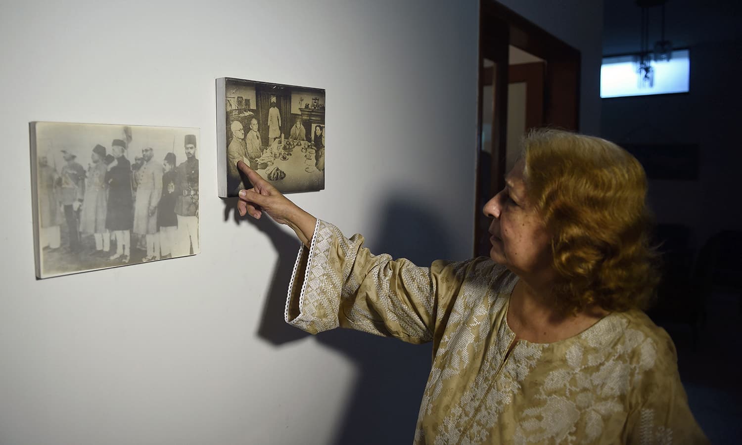 Jahan Ara points out a historical picture showing Mohammad Ali Jinnah, the founding father of Pakistan, Liaqat Ali Khan, the first Pakistani prime minister along with her paternal uncle. — Photo by AFP