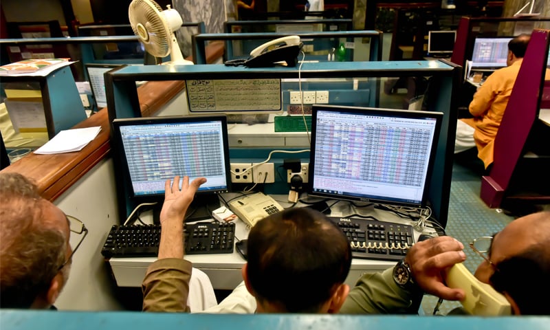 KARACHI: Stock brokers monitor share prices on Friday at the Pakistan Stock Exchange. The market opened on a jittery note as profit-taking led to an intraday loss of 1,670 points. However, optimism returned to the market afterwards, with the KSE-100 index closing up by 6.3 points.—Fahim Siddiqi/White Star