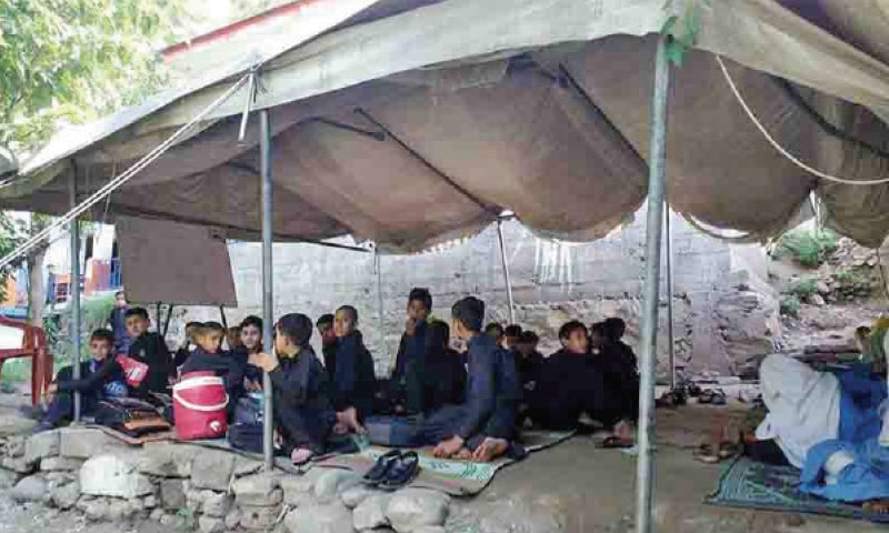 Students of the quake-hit school attend a class in a tent. — Dawn Students of the quake-hit school attend a class in a tent. — Dawn