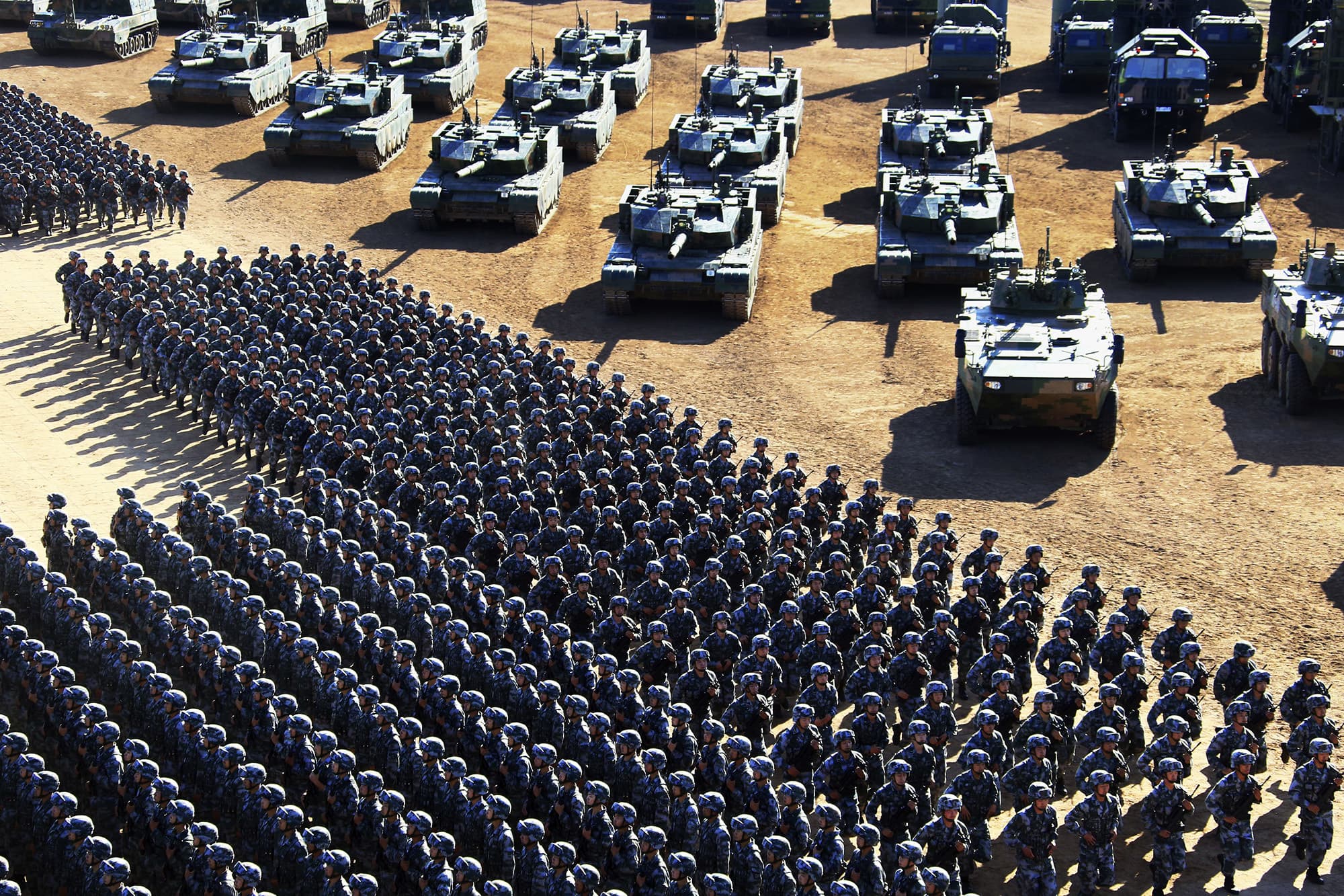 In this photo released by China's Xinhua News Agency, Chinese People's Liberation Army (PLA)  troops march past military vehicles Sunday, July 31, 2017 as they arrive for a military parade to commemorate the 90th anniversary of the founding of the PLA. ─ AP