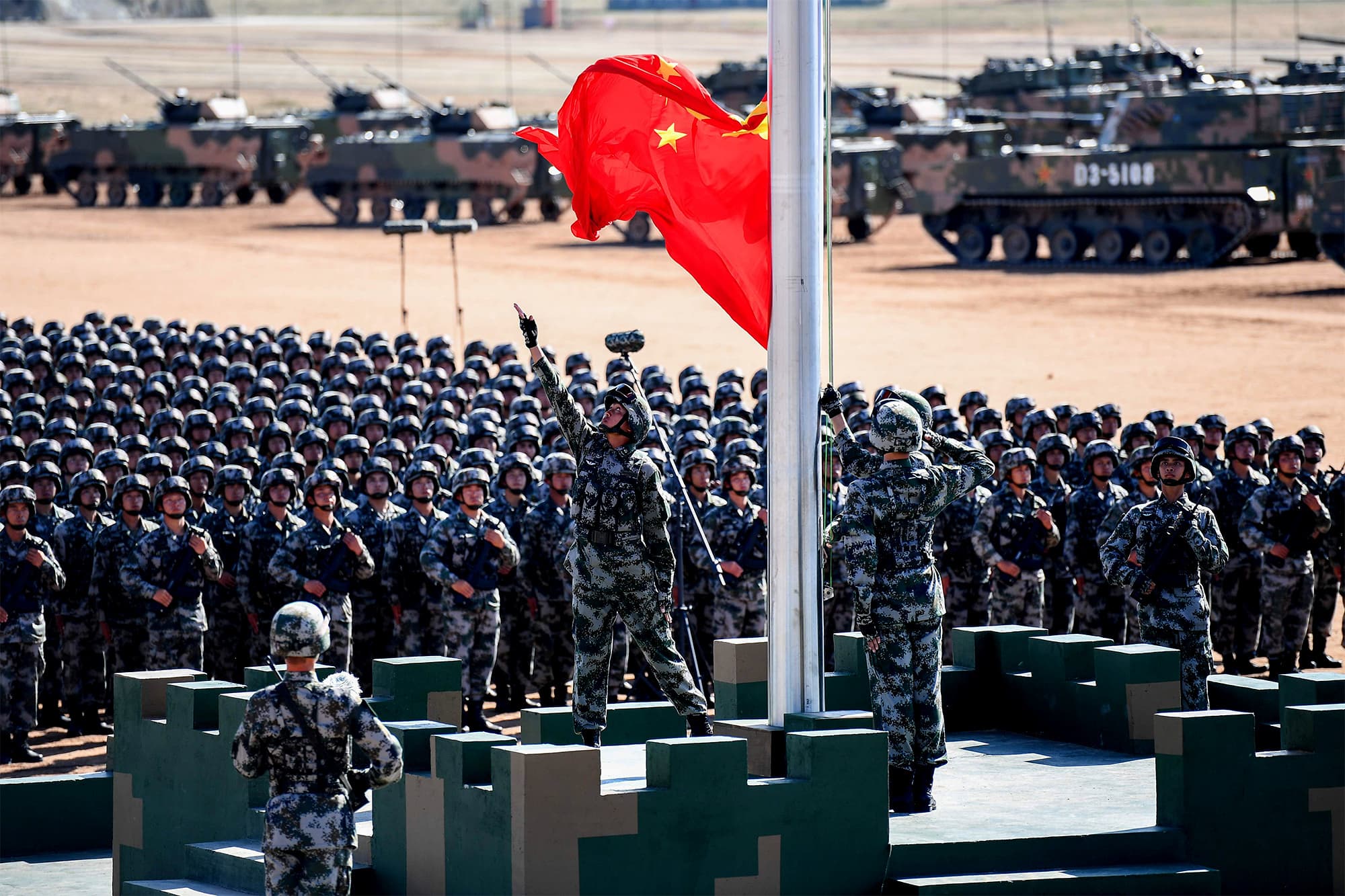 The Chinese flag is raised during a military parade at the Zhurihe training base in China's northern Inner Mongolia region on July 30, 2017. ─ AFP