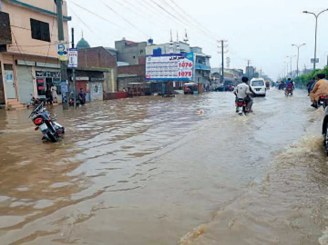Rainwater inundates roads in Sialkot city. &mdash; Dawn