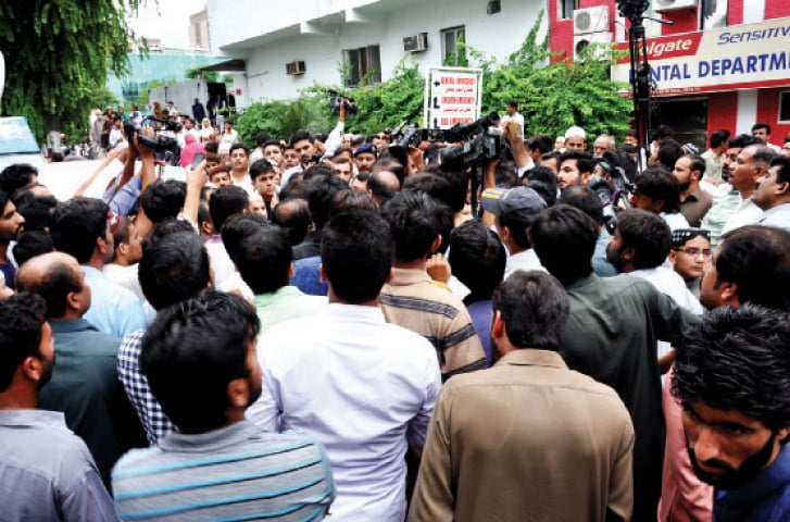 Relatives and friends of the deceased gather on the premises of the hospital on Wednesday. &mdash; Photo by Mohammad Asim