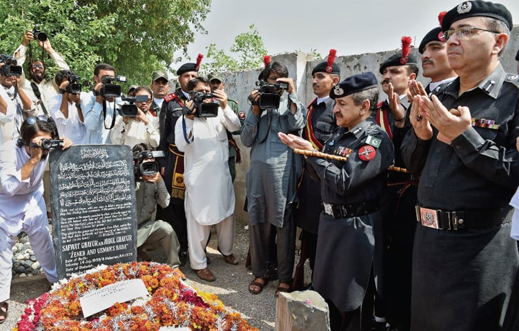 FC commandant Liaquat Ali Khan and other officers pray on the grave of former FC commandant Shaheed Safwat Ghayur in Peshawar on Friday. &mdash; White Star