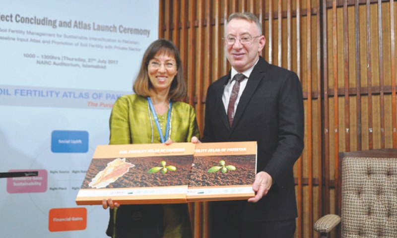 USAID Mission Director Jerry Bisson receiving a copy of the atlas from Mina Dawlatchahi, FAO representative to Pakistan.