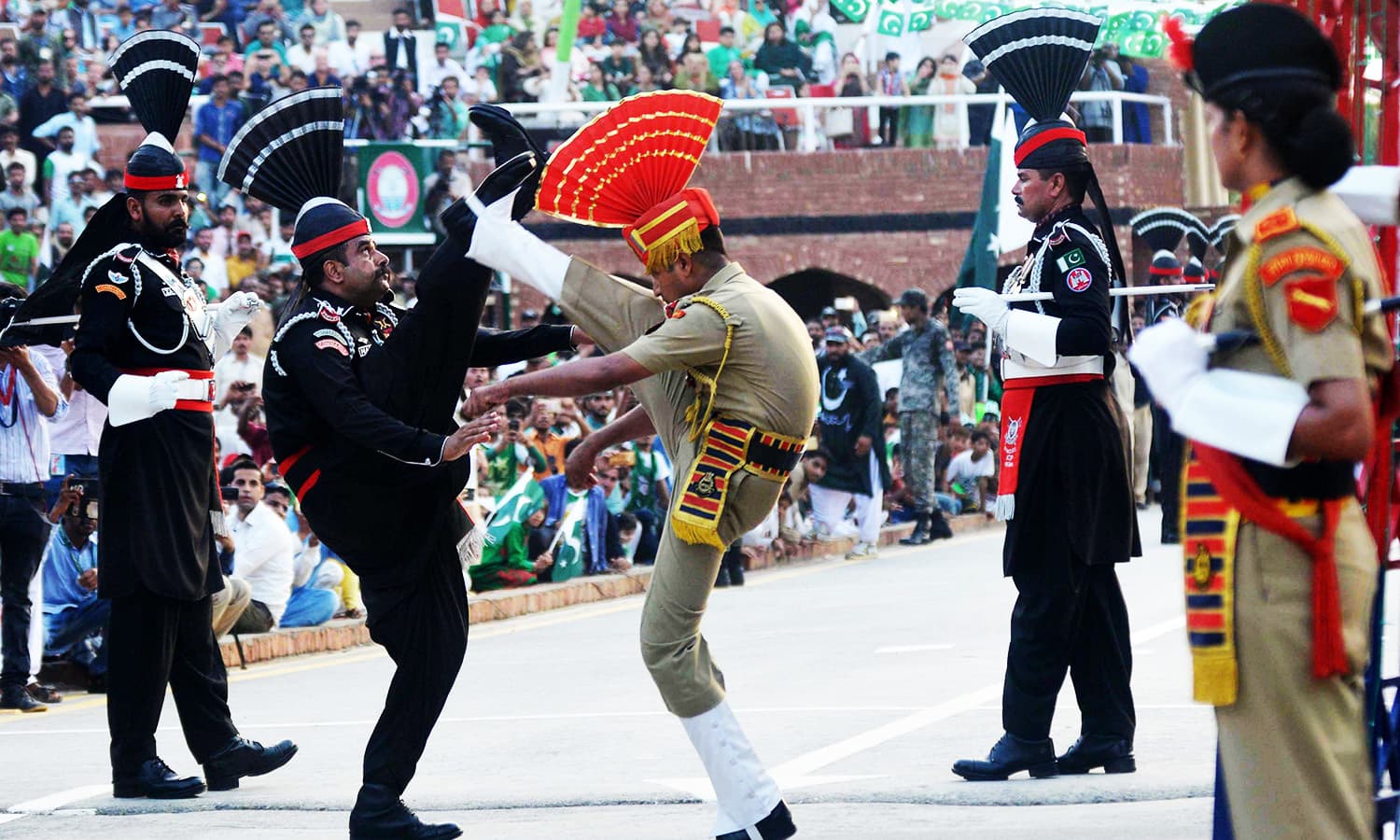 Pakistani Rangers and Indian Border Security Force personnel perform during the daily beating of the retreat ceremony at the India-Pakistan Wagah Border Post.—AFP