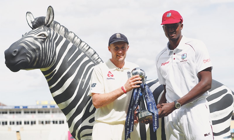 RIVAL captains, England’s Joe Root (L) and Jason Holder of the West Indies, pose with the series trophy on the eve of the first Test at Edgbaston.—Reuters