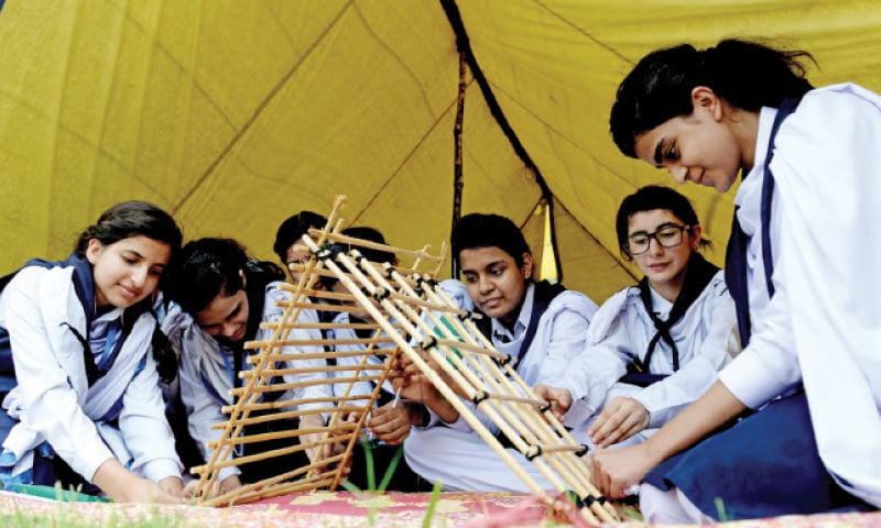 Girl scouts assemble a model of an emergency bridge. — Photos by Mohammad Asim