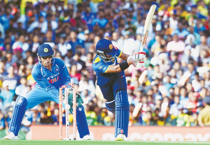 DAMBULLA: Sri Lankan batsman Kusal Mendis is cleaned up by Indian spinner Axar Patel as wicket-keeper M.S. Dhoni looks on during the first One-day International at the Rangiri Dambulla International Cricket Stadium on Sunday.—AFP