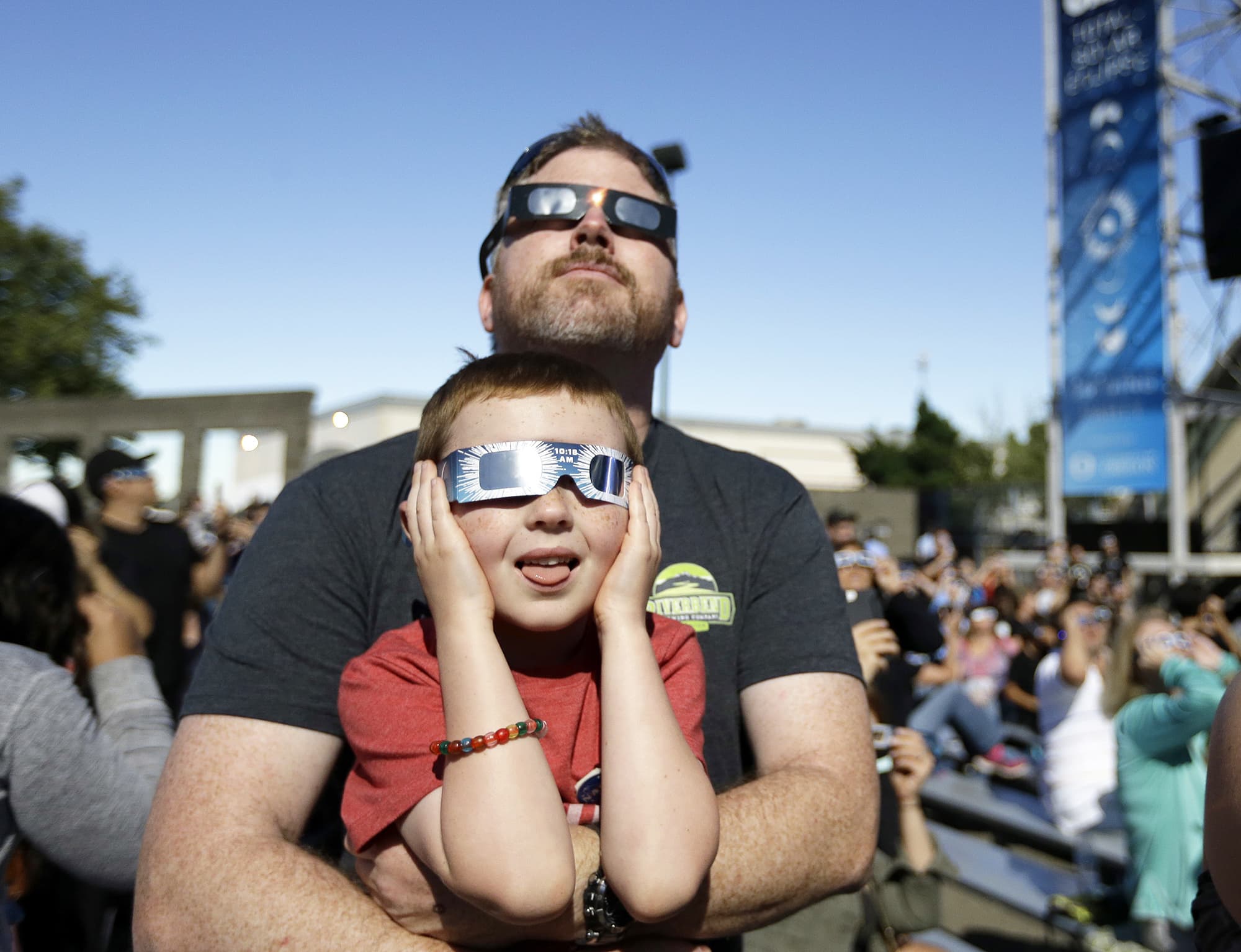 Dan Blanchette and his son, Sam, 6, watch the final phases of a total solar eclipse in Salem, Oregon, USA.—AP