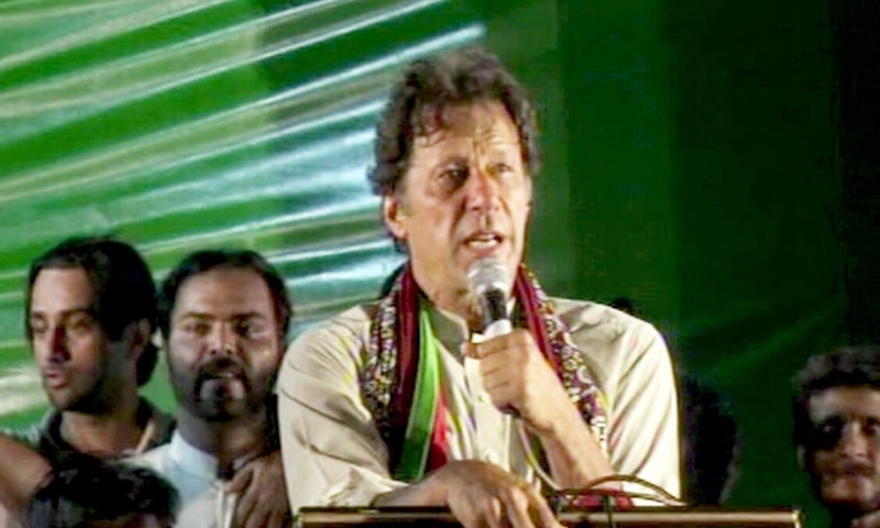 Donning a traditional ajrak scarf, PTI Chairman Imran Khan hits out at former president Asif Zardari in Sukkur on August 25. — DawnNews