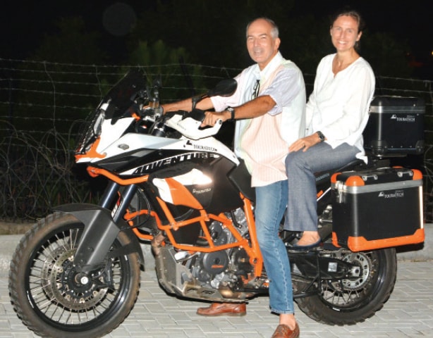 Ambassador Jeanette Seppen and her husband Charles Petri on their motorbike as they prepare to travel from Pakistan to the Netherlands on their two-wheeler.