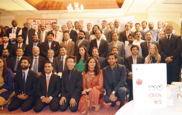A group photo of AJK President Sardar Masood Khan and other guests at a dinner in Islamabad.