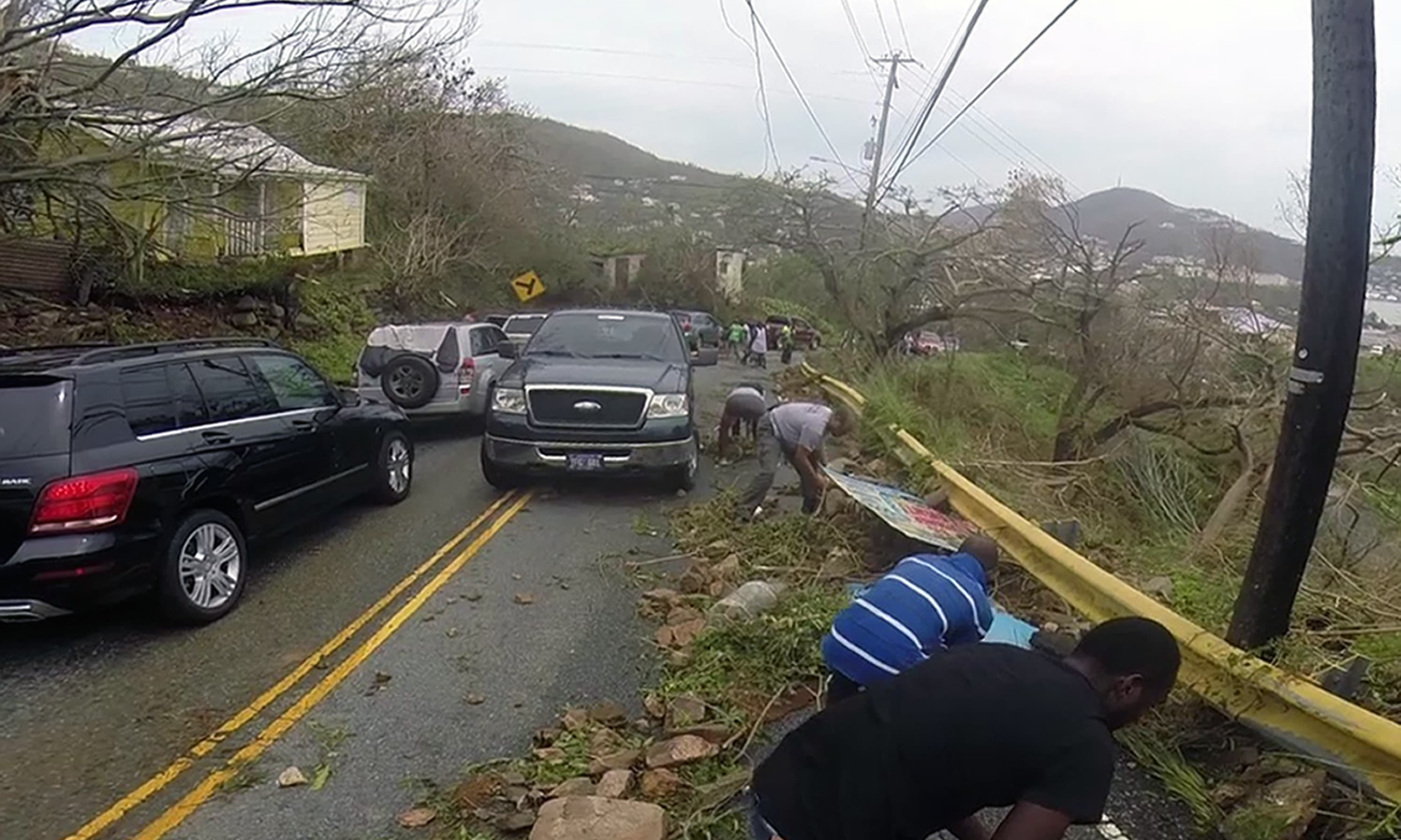 Motorists remove debris caused by Hurricane Irma from the road in St. Thomas, US Virgin Islands. —AP