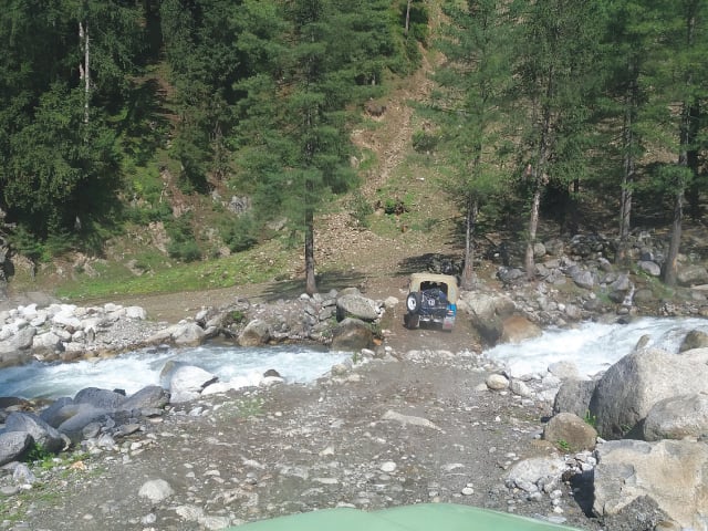 Crossing a stream in a jeep