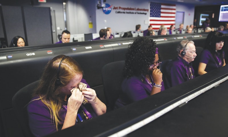 Engineer Nancy Vandermay (left) wipes her tears in mission control at Nasa&rsquo;s Jet Propulsion Laboratory after confirmation of Cassinis demise on Friday.&mdash;AP