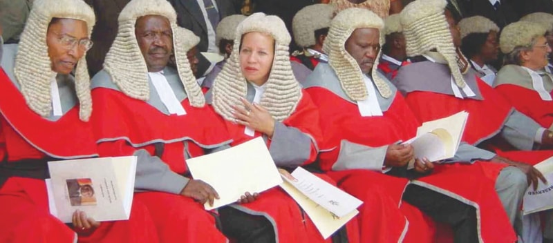 high court judges in Zimbabwe wear long, white wigs and red robes, a glaring symbol of colonial inheritance.