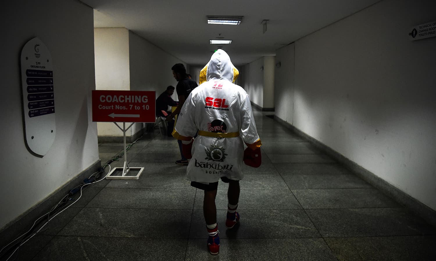 Boxer Venkat Naik with the Bahubali Boxers team walks towards the arena for his fight during a Super Boxing League event in New Delhi.&mdash; AFP