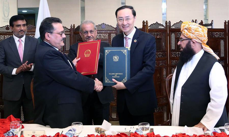 Chinese Ambassador to Pakistan Sun Weidong and  Senate Secretary Amjed Pervez Malik shake hands after signing handover document in Islamabad. &mdash;Xinhua