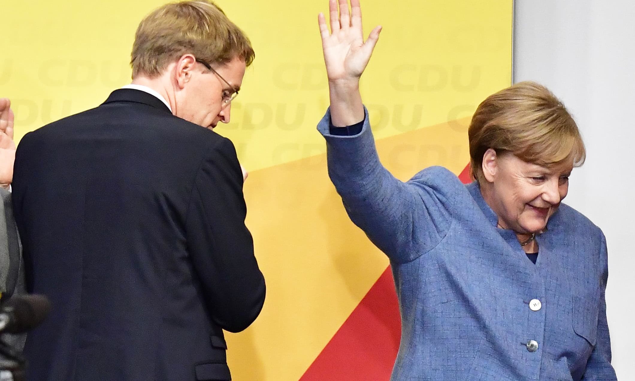 German Chancellor and Christian Democrats party (CDU) leader Angela Merkel (R) leaves the stage after speaking during an election night event at the CDU party's headquarters in Berlin during the general election on September 24, 2017. —AFP German Chancellor and Christian Democrats party (CDU) leader Angela Merkel (R) leaves the stage after speaking during an election night event at the CDU party's headquarters in Berlin during the general election on September 24, 2017. —AFP