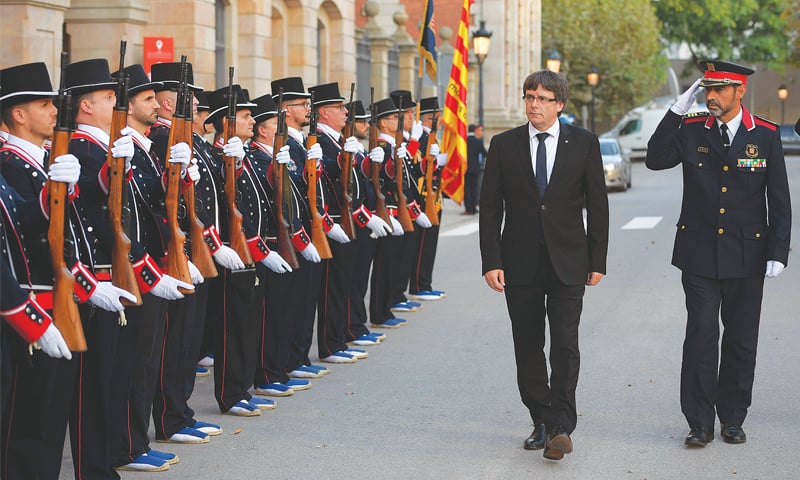 PRESIDENT of the Catalan regional government Carles Puigdemont along with chief of police Josep Lluis Trapero (right) inspects the Catalan regional police troops before attending a ceremony in Barcelona on Sept 10.&mdash;AFP