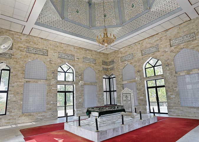 The interior of the mausoleum and the grave of Sultan Mohammad Ghori. White marble has been used on the walls and the roof is decorated with minakari.