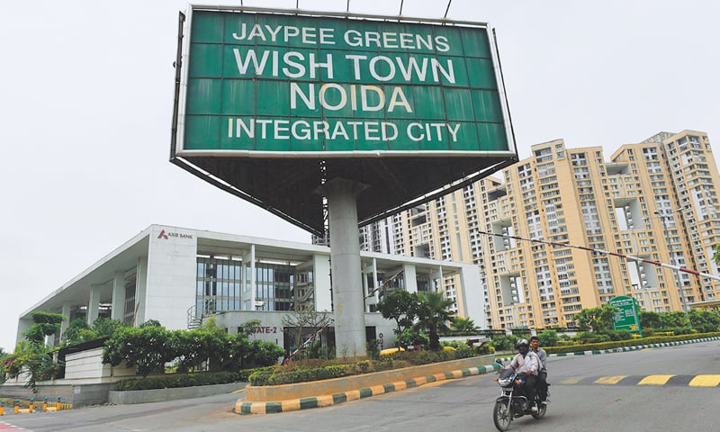 A vehicle passing by an entry gate of Jaypee’s wish town in Noida, a suburb of New Delhi. Hundreds of homebuyer’s petitioned India’s top court to challenge the country’s insolvency law, their lawyer said, amid fears that bad loan problems are spilling over to hurt ordinary people.—AFP