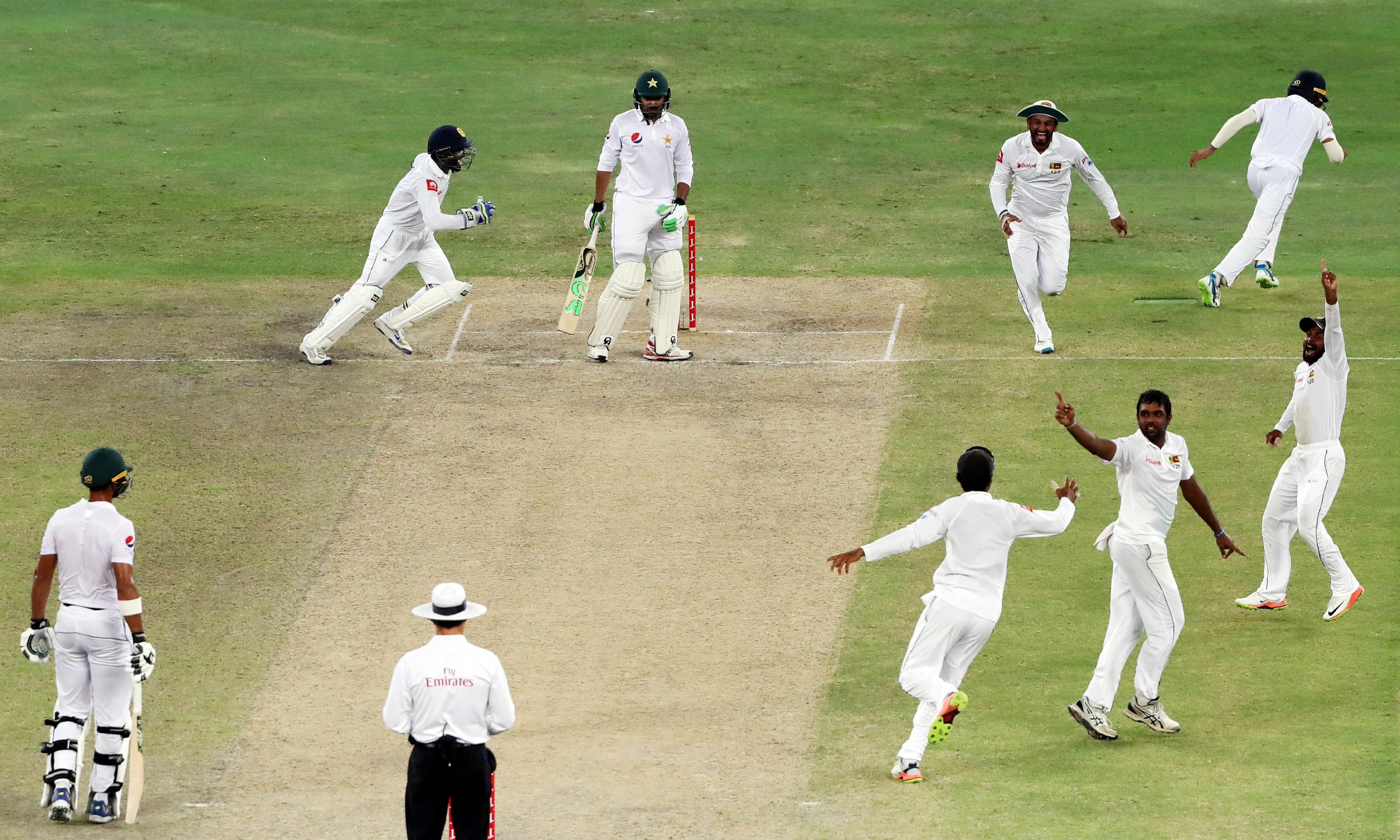 Sri Lanka's players celebrate the dismissal of Azhar Ali during the fourth day of the second Test. —AFP