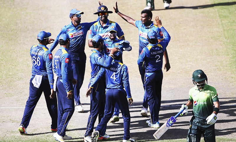 Sri Lanka players celebrate dismissal of Ahmed Shehzad. —AP