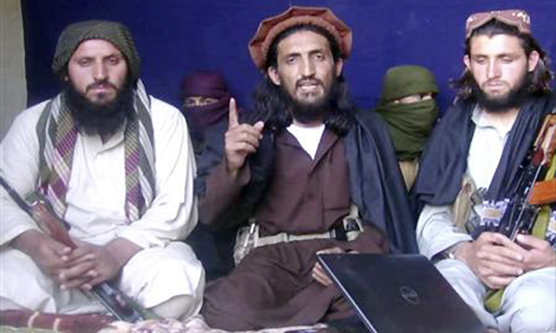 Omar Khalid Khorasani is seen in the centre during an interview in Mohmand tribal region on June 2, 2011. —Reuters/File