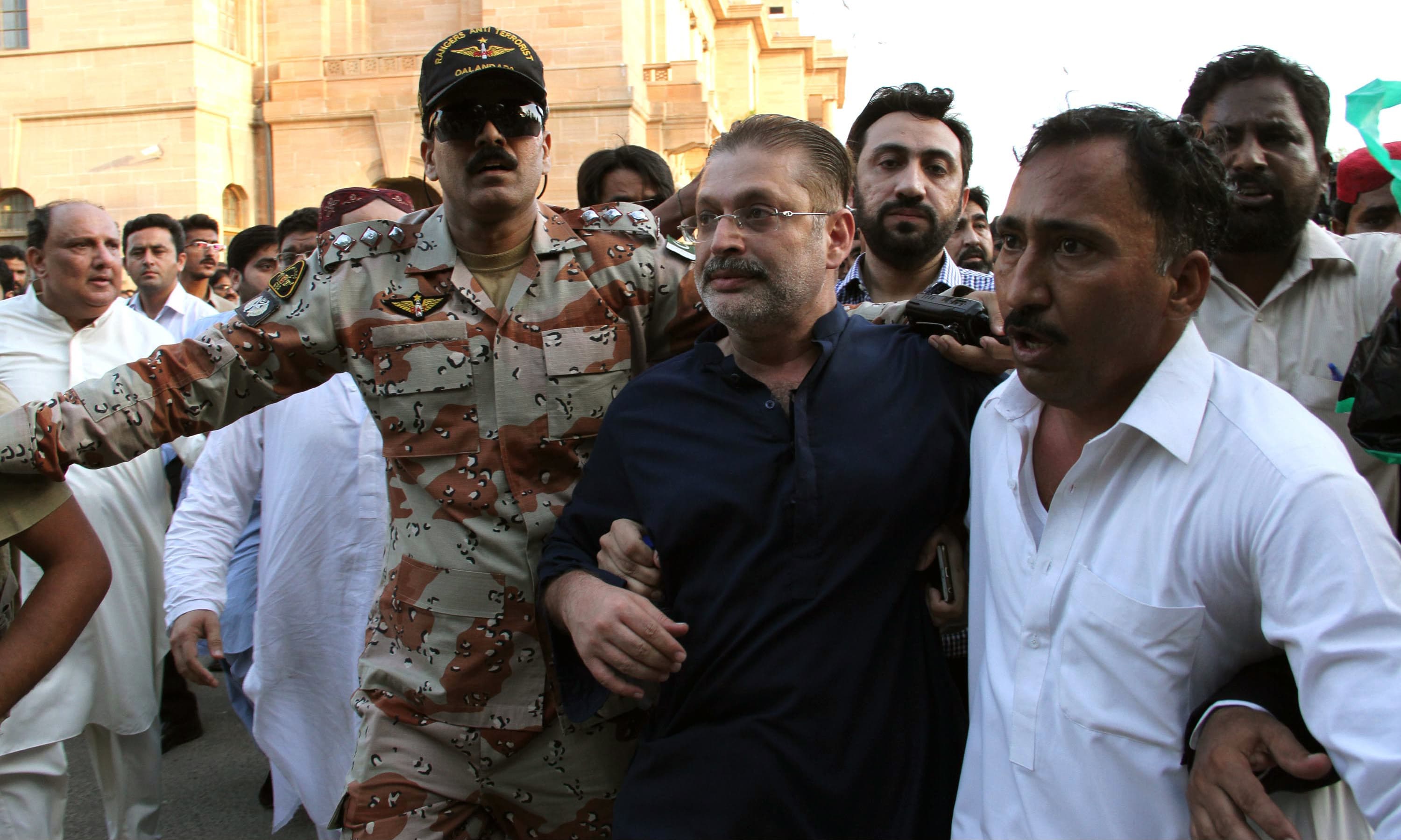 Security personnel arrest PPP leader Sharjeel Memon. —PPI