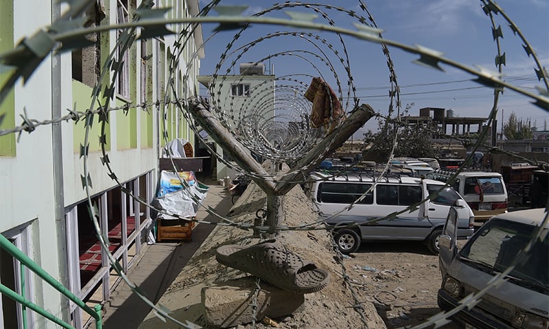 A sandal belonging to a victim hanging on barbed wire outside Imam Zaman mosque. ─ AFP