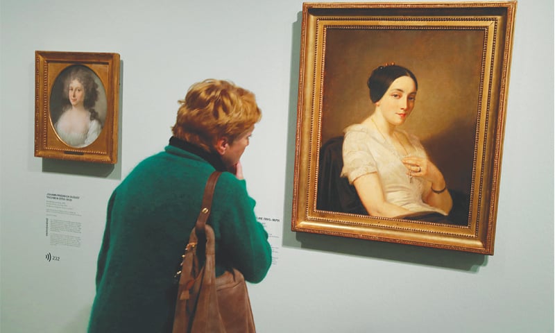 Bonn (Germany): A woman looks at &ldquo;Portrait of a Young Woman&rdquo;, an oil painting  by French artist Thomas Couture (1815-1879), .The painting was identified as a Nazi-looted work during a media preview of the &ldquo;Gurlitt Status Report - Nazi Art Theft and its Consequences&rdquo; exhibition at the Bundeskunsthalle.&mdash;Reuters