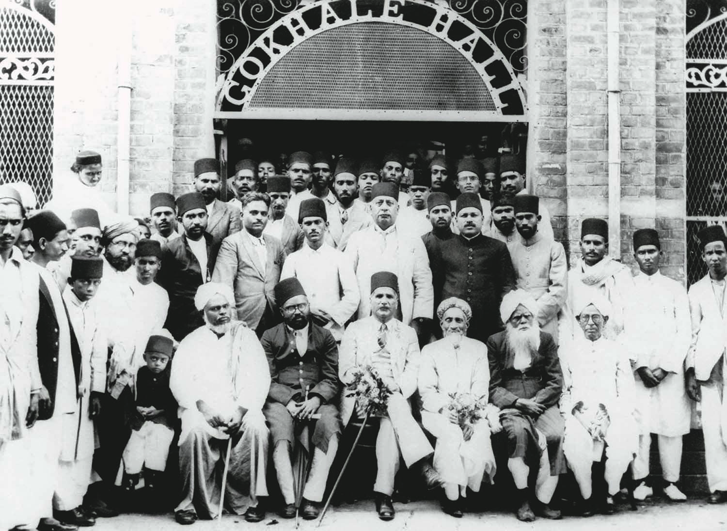 Allama Muhammad Iqbal (front row; centre) at the Gokhale Hall in Madras (since renamed Chennai) in 1929 after he had delivered one of his several famous lectures. The hall was named after Gopal Krishna Gokhale, a close friend of Quaid-i-Azam Mohammad Ali Jinnah, and a senior member of the Indian National Congress. | Photo: The Allama Iqbal Collection.