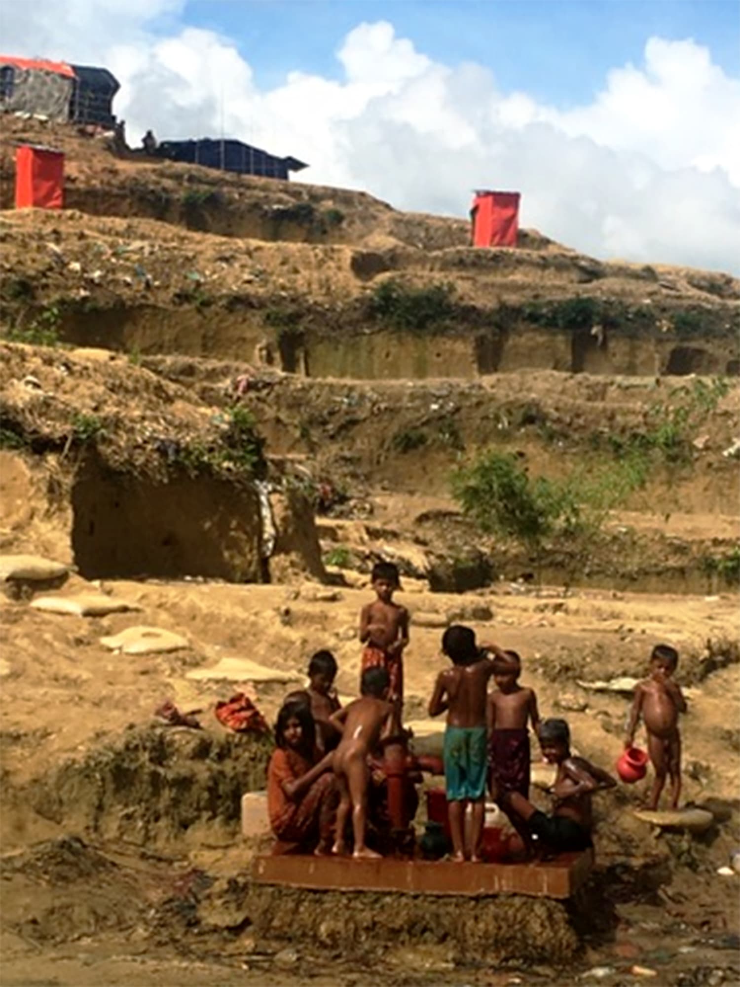 Children play by the water pump at the base of the refugee camp. -All photos by author unless stated otherwise