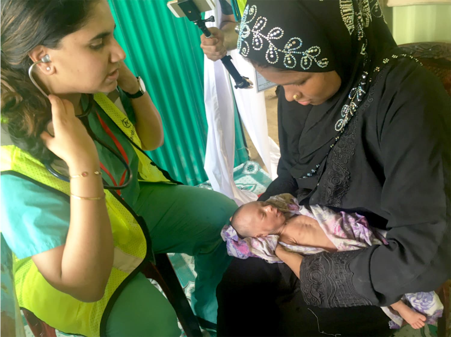 Dr. Minal Ahson examining a very small newborn.