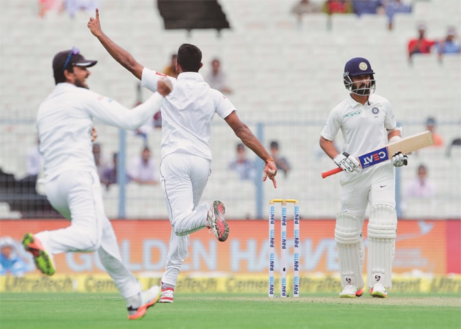 SRI LANKAN captain Dinesh Chandimal (L) and paceman Dasun Shanaka celebrate the dismissal of Indian batsman Ajinkya Rahane.&mdash;AP